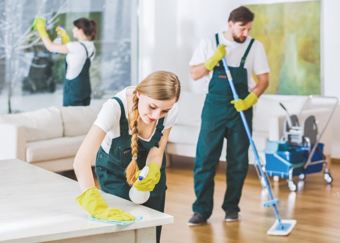Cleaning service employees with professional equipment cleaning a private home after renovation
